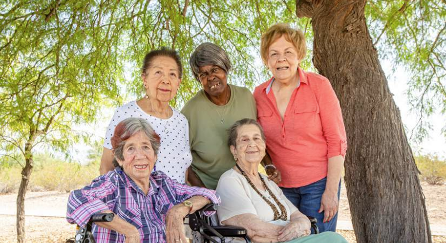 Group of older women of different cultures, smiling.